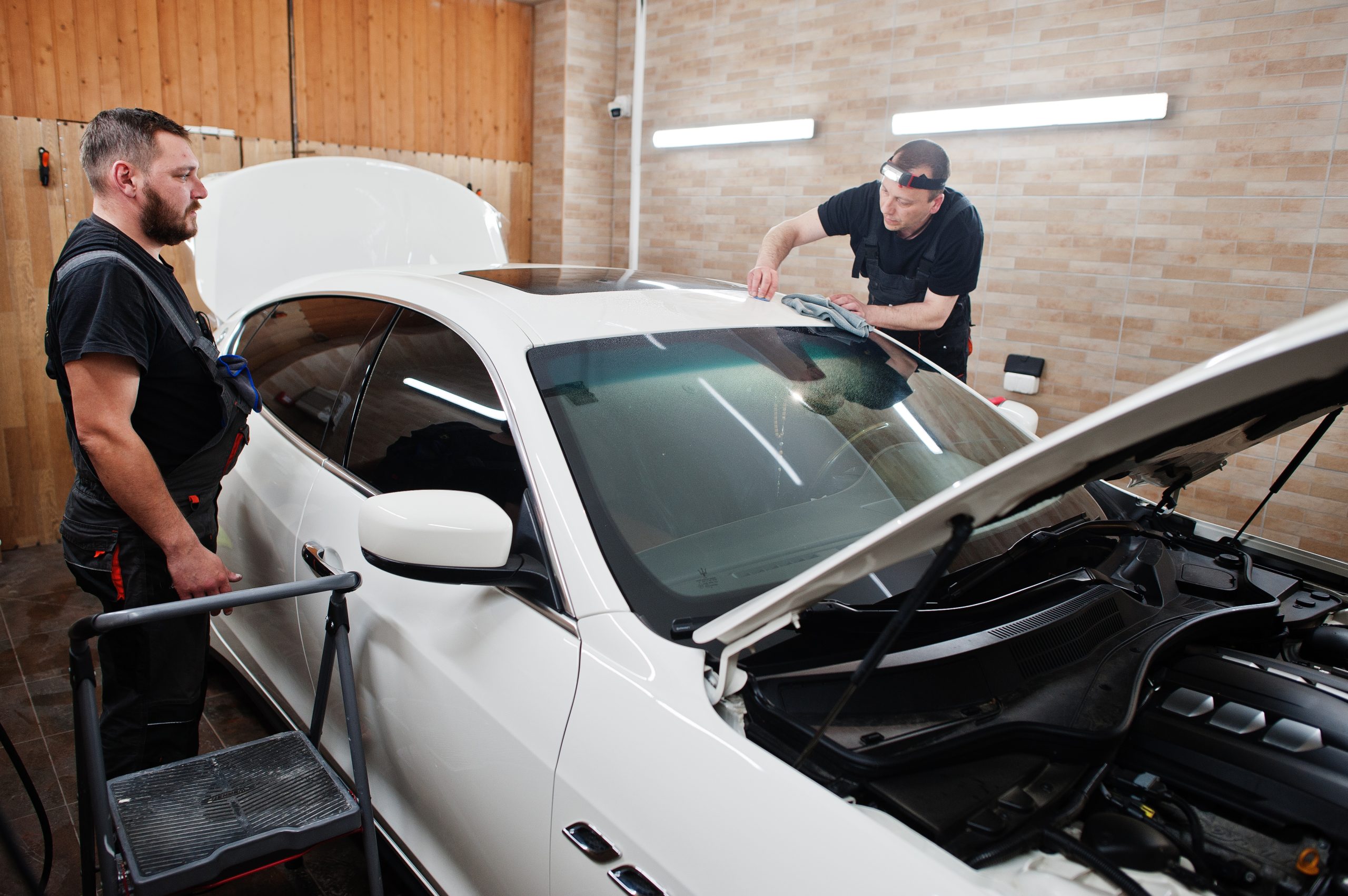 Mobile auto glass technician working at a customer's location